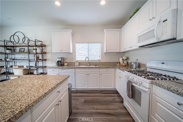 kitchen featuring white cabinetry, white appliances, and sink