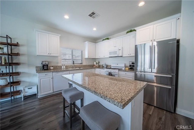 kitchen with white cabinets and white appliances