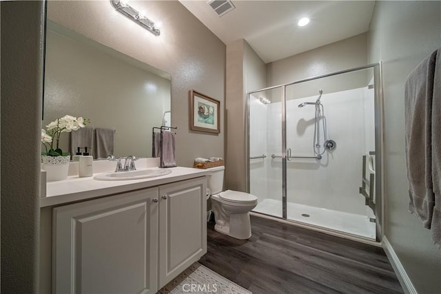 bathroom with vanity, hardwood / wood-style floors, toilet, and walk in shower