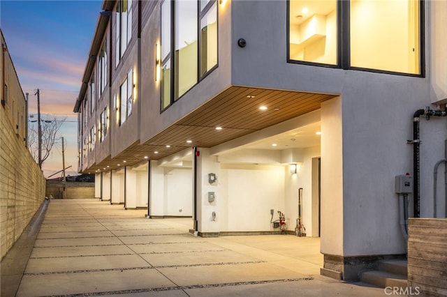 exterior space featuring a patio area and stucco siding