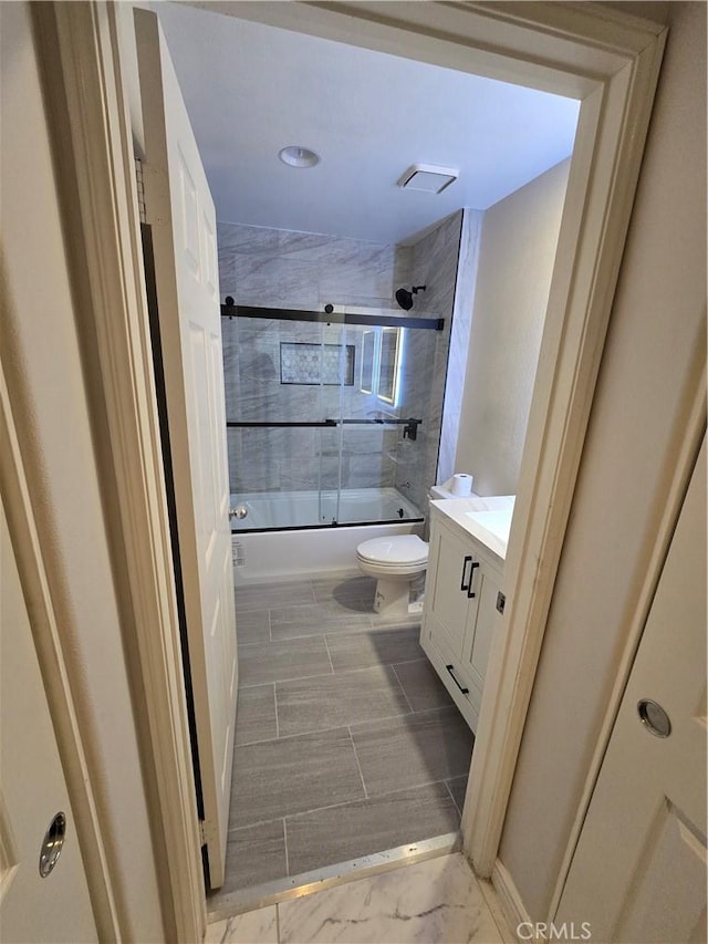 bathroom with visible vents, shower / bath combination with glass door, vanity, and toilet