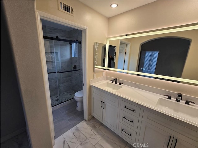 bathroom with vanity, an enclosed shower, and toilet