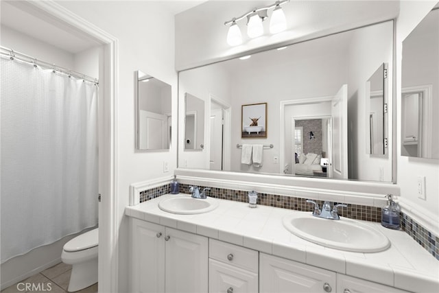 full bathroom featuring decorative backsplash, tile patterned flooring, vanity, toilet, and shower / bath combo