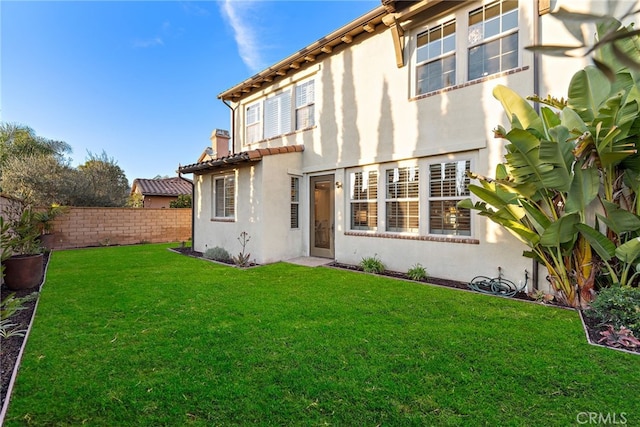 rear view of house with a yard