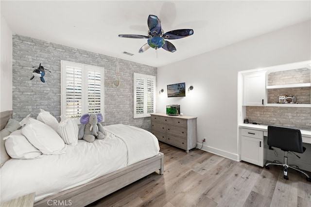 bedroom featuring ceiling fan, built in desk, and light wood-type flooring