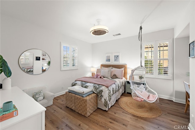 bedroom featuring hardwood / wood-style flooring and multiple windows