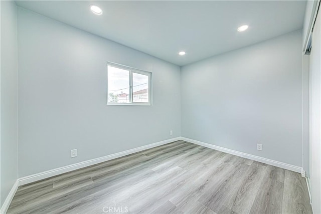 unfurnished room with light hardwood / wood-style floors