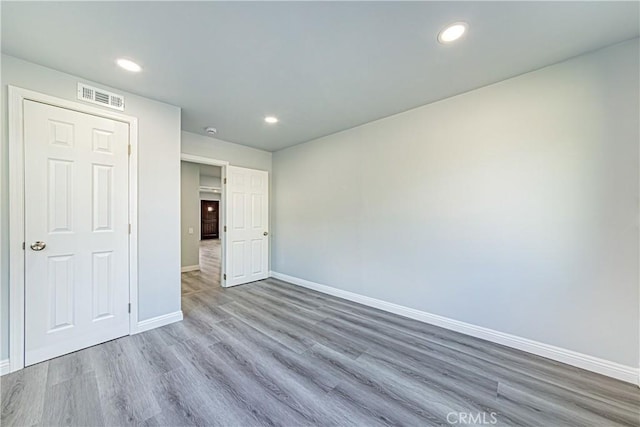 unfurnished bedroom with hardwood / wood-style flooring