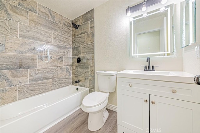 full bathroom featuring vanity, hardwood / wood-style flooring, toilet, and tiled shower / bath combo