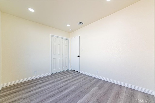 unfurnished room with light wood-type flooring