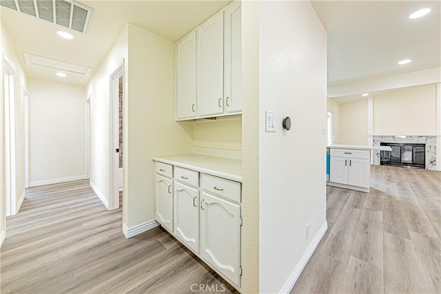 hallway with light hardwood / wood-style floors