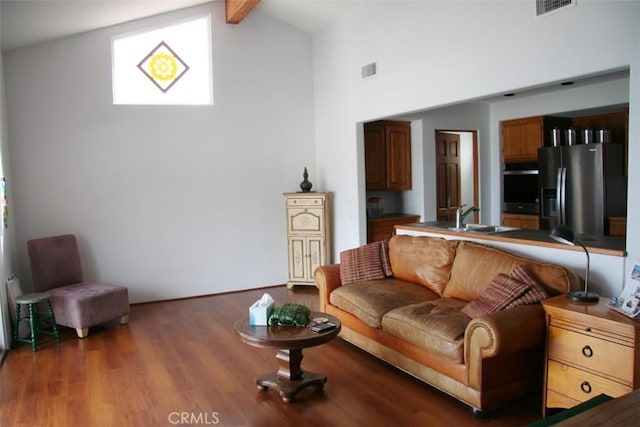 living room with dark wood-type flooring, high vaulted ceiling, sink, and beamed ceiling