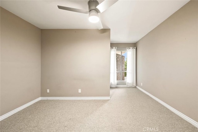 unfurnished room featuring ceiling fan and carpet floors