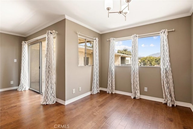 interior space with dark hardwood / wood-style flooring, a notable chandelier, and ornamental molding