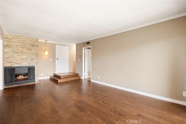 unfurnished living room with hardwood / wood-style floors, a stone fireplace, and ornamental molding