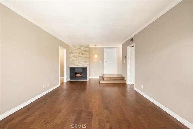 unfurnished living room with dark wood-type flooring, ornamental molding, and a fireplace