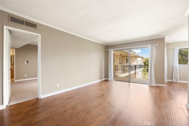 empty room with hardwood / wood-style flooring and ornamental molding