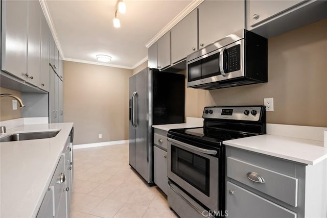 kitchen with crown molding, appliances with stainless steel finishes, sink, and gray cabinetry