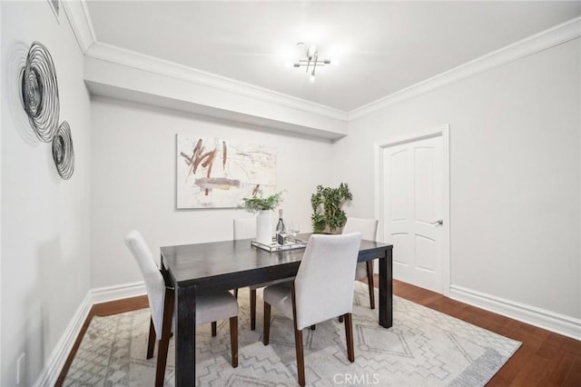 dining room featuring hardwood / wood-style flooring and ornamental molding