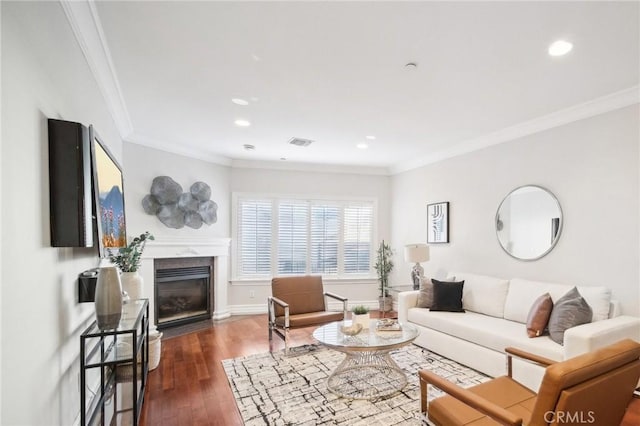 living room with crown molding, dark wood-type flooring, and a high end fireplace