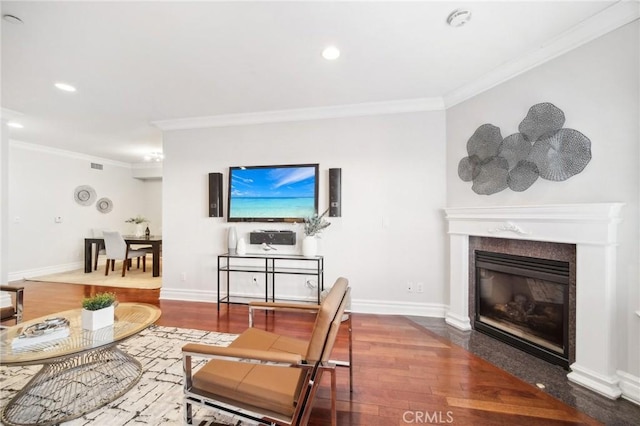 living room featuring crown molding, a fireplace, and dark hardwood / wood-style flooring