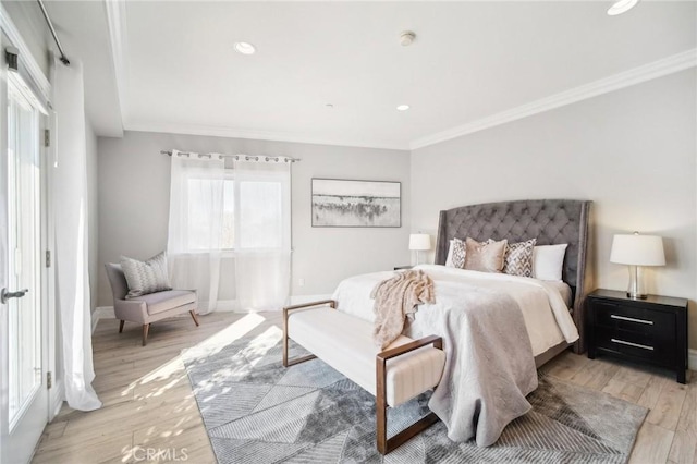 bedroom with crown molding and light hardwood / wood-style floors