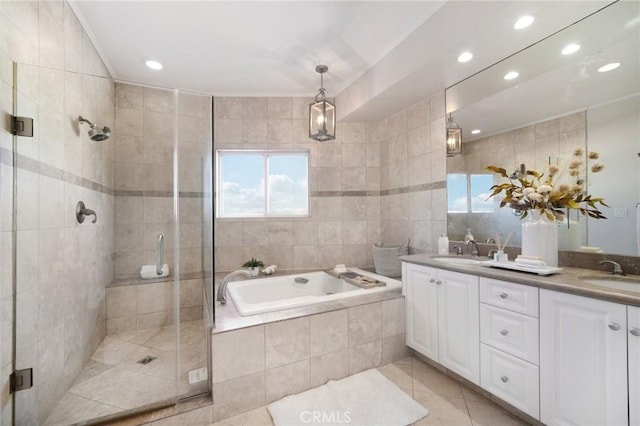 bathroom featuring crown molding, tile patterned floors, shower with separate bathtub, and vanity