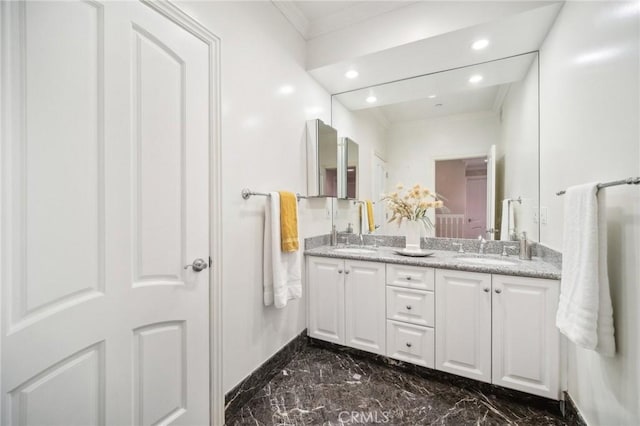 bathroom with crown molding and vanity