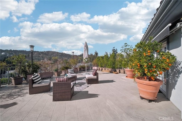 view of patio / terrace with an outdoor living space and a mountain view