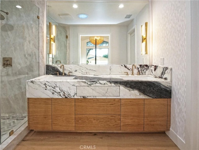 bathroom featuring vanity, hardwood / wood-style floors, and walk in shower