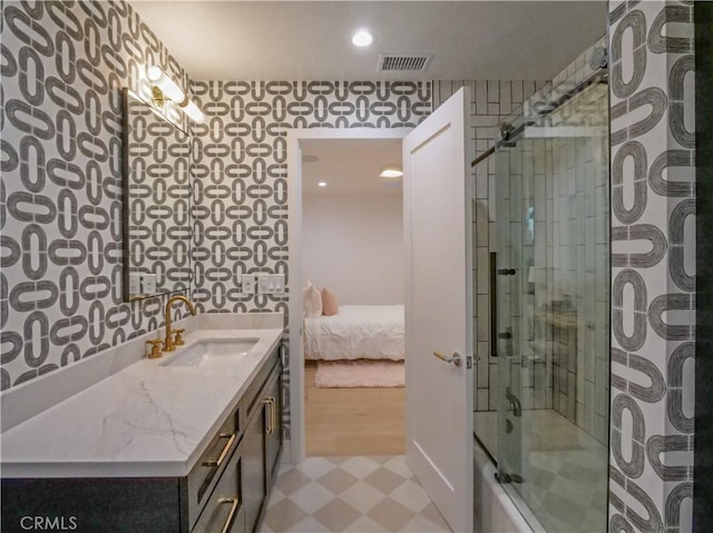 bathroom with enclosed tub / shower combo and vanity