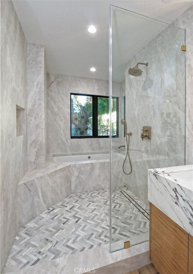 bathroom featuring vanity and a tile shower