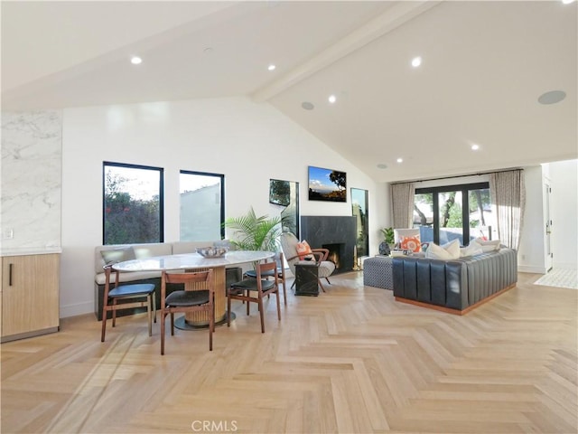 dining room with beamed ceiling, a premium fireplace, high vaulted ceiling, and light parquet floors