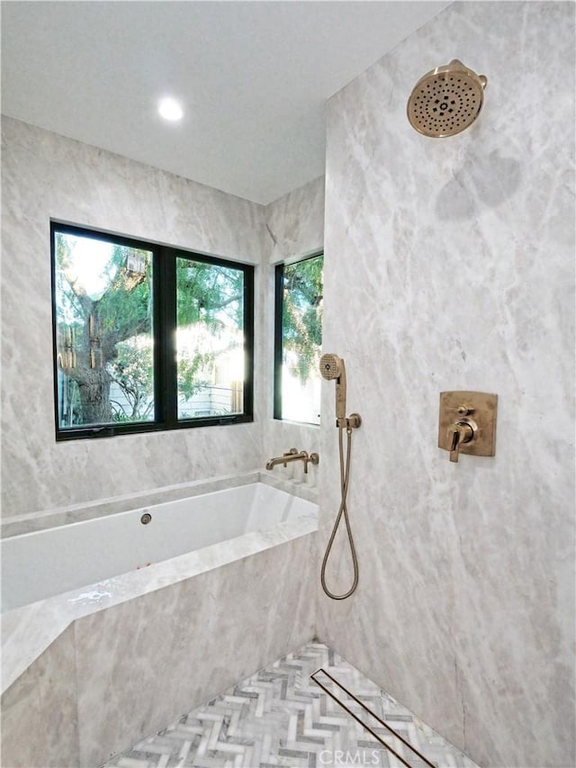 bathroom featuring shower with separate bathtub