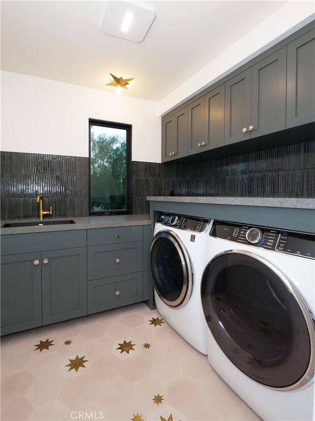 laundry area with sink, cabinets, and washing machine and clothes dryer