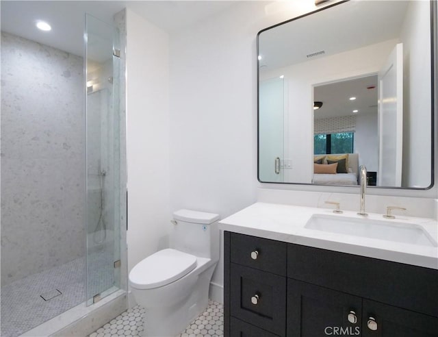 bathroom with vanity, toilet, a shower with shower door, and tile patterned flooring