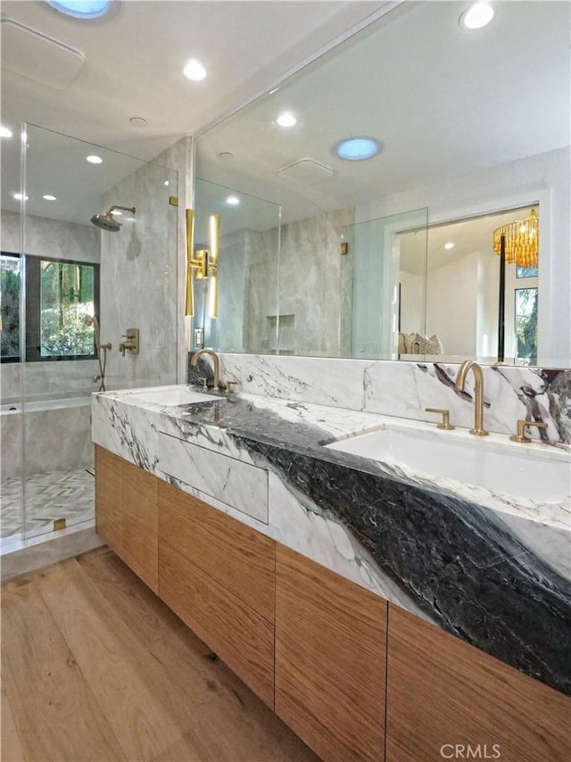 bathroom featuring an enclosed shower, hardwood / wood-style floors, and vanity