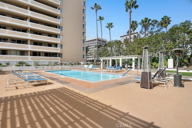 view of swimming pool with a pergola and a patio