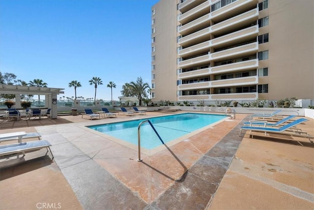 view of swimming pool featuring a pergola and a patio area