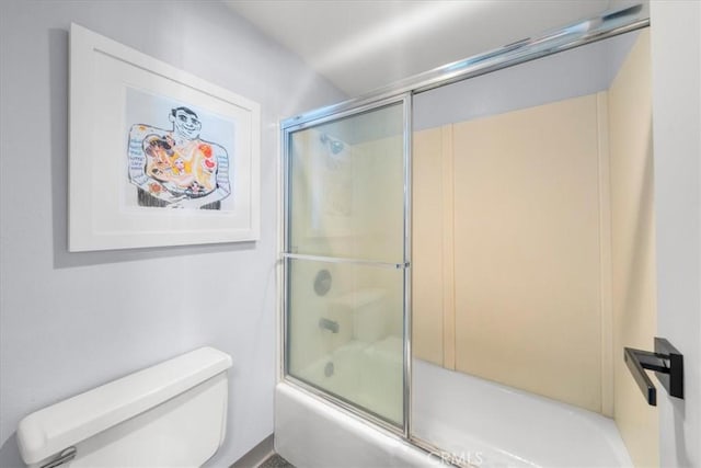 bathroom with shower / bath combination with glass door and toilet