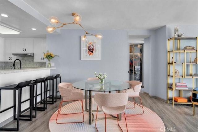 dining area featuring sink and light hardwood / wood-style flooring