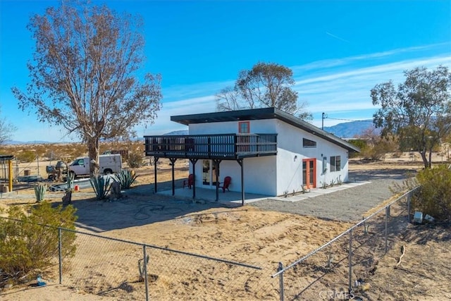 exterior space with a patio area and a deck with mountain view