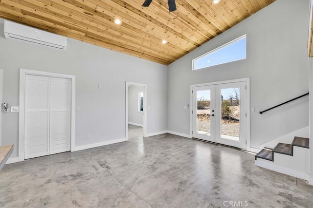 unfurnished living room with wood ceiling, concrete floors, an AC wall unit, and french doors