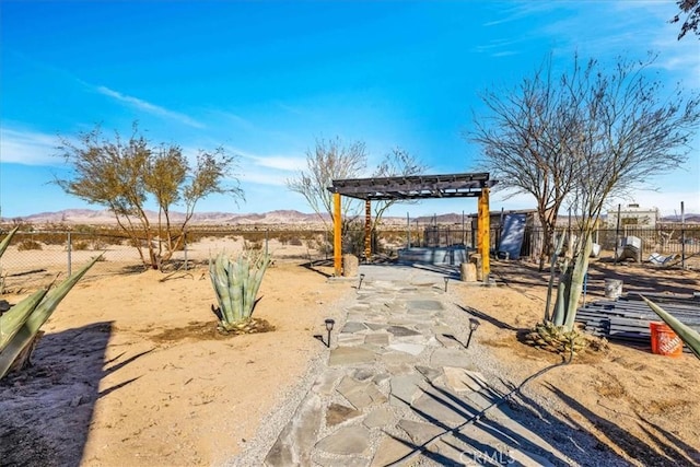 exterior space featuring a mountain view and a pergola