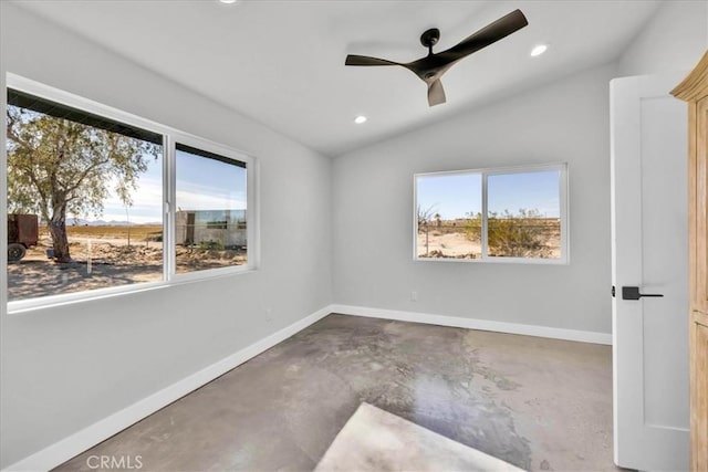 empty room with concrete flooring, lofted ceiling, a healthy amount of sunlight, and ceiling fan