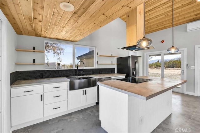 kitchen featuring pendant lighting, sink, appliances with stainless steel finishes, white cabinets, and a kitchen island