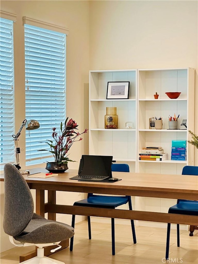 office with a wealth of natural light and light hardwood / wood-style floors