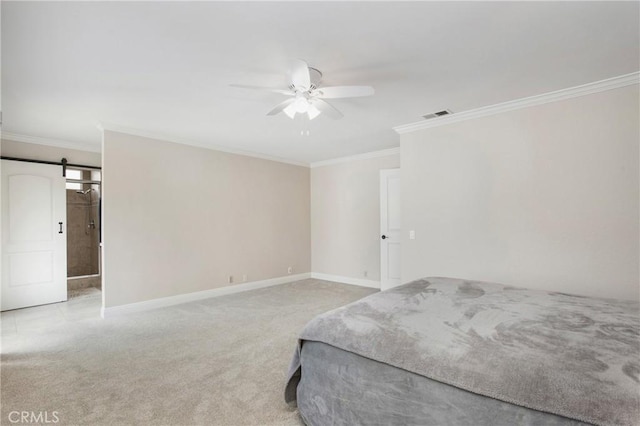 carpeted bedroom with ornamental molding, a barn door, and ceiling fan