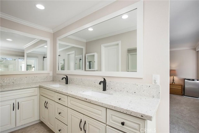 bathroom with ornamental molding and vanity