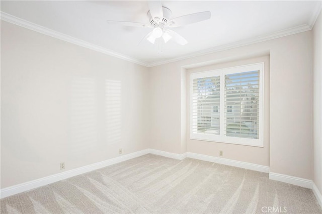 unfurnished room with ornamental molding, light colored carpet, and ceiling fan